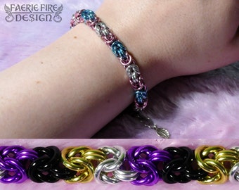 May include: A braided bracelet with alternating colors of purple, black, gold, and silver. The bracelet is made of metal and has a leaf-shaped charm.