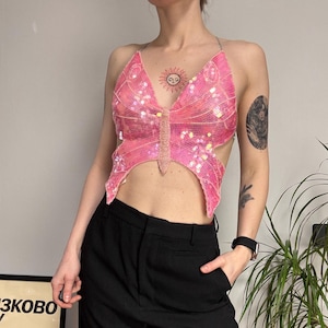 May include: A white ceramic mug with a black handle and the text "But First, Coffee" in a handwritten style. The mug is on a white surface. The mug is approximately 4 inches tall.