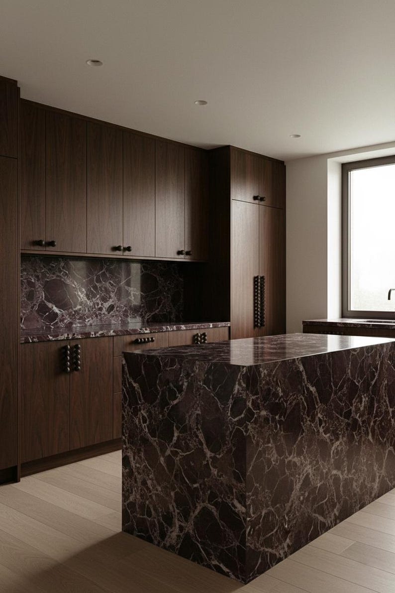 May include: A modern kitchen with dark wood cabinetry and a large island. The countertops and backsplash feature a striking marble pattern in shades of burgundy and white. The room has a minimalist design with a window providing natural light.