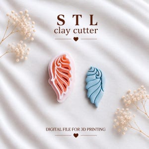 May include: A light pink clay cutter with a wing-shaped design and a matching light blue wing-shaped clay piece. The text reads STL clay cutter and DIGITAL FILE FOR 3D PRINTING. The design features intricate curved lines and a pointed tip.