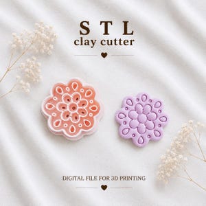 May include: A peach-colored flower-shaped clay cutter and a matching lavender-colored flower-shaped clay piece. The text reads STL clay cutter and DIGITAL FILE FOR 3D PRINTING. The items are arranged on a white fabric surface with small white flowers.
