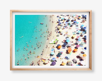 May include: An aerial view of a crowded beach with turquoise water and white sand. Colorful umbrellas and beach chairs are scattered across the sand. The text "good vibes motel" is written in black cursive at the bottom of the image.