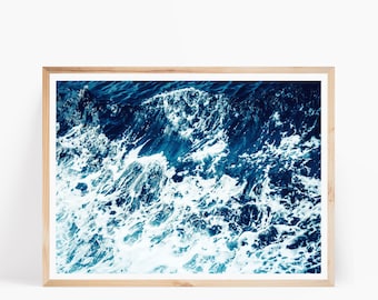 May include: A framed photograph of a close-up of ocean waves crashing, with a deep blue and white color scheme.