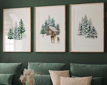 May include: A green living room with a sectional sofa, a coffee table, and three framed watercolor paintings of winter scenes with a cabin and deer. The paintings are hung on a green wall.
