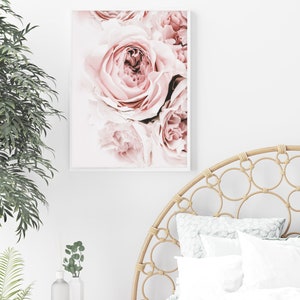 May include: A close-up of a bouquet of pink roses. The roses are in focus, and the background is blurred. The image is soft and romantic.