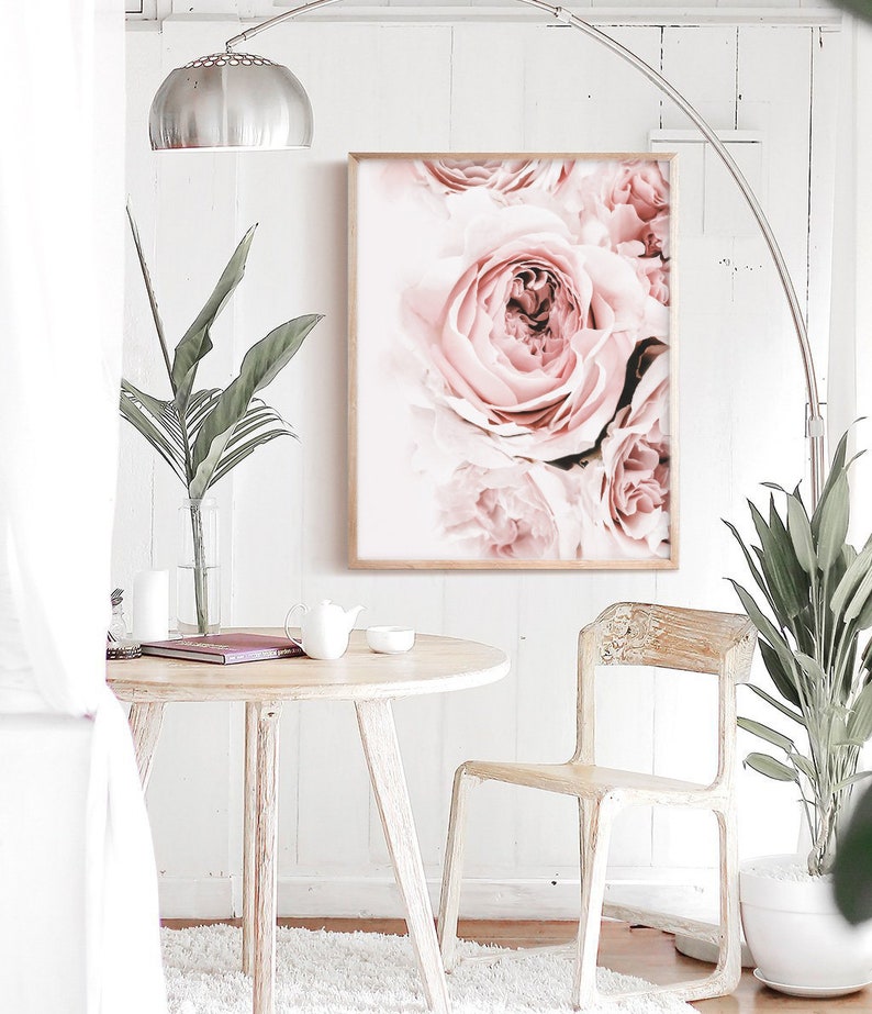 May include: A close-up of a framed print featuring a cluster of soft pink roses. The roses are arranged in a bouquet-like formation, with the petals overlapping and creating a delicate and romantic aesthetic.