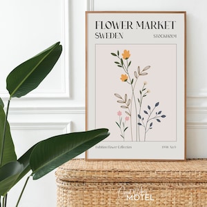 May include: A framed poster with a floral illustration and the text "FLOWER MARKET SWEDEN STOCKHOLM Exhibition Flower Collection 1998 No.9"