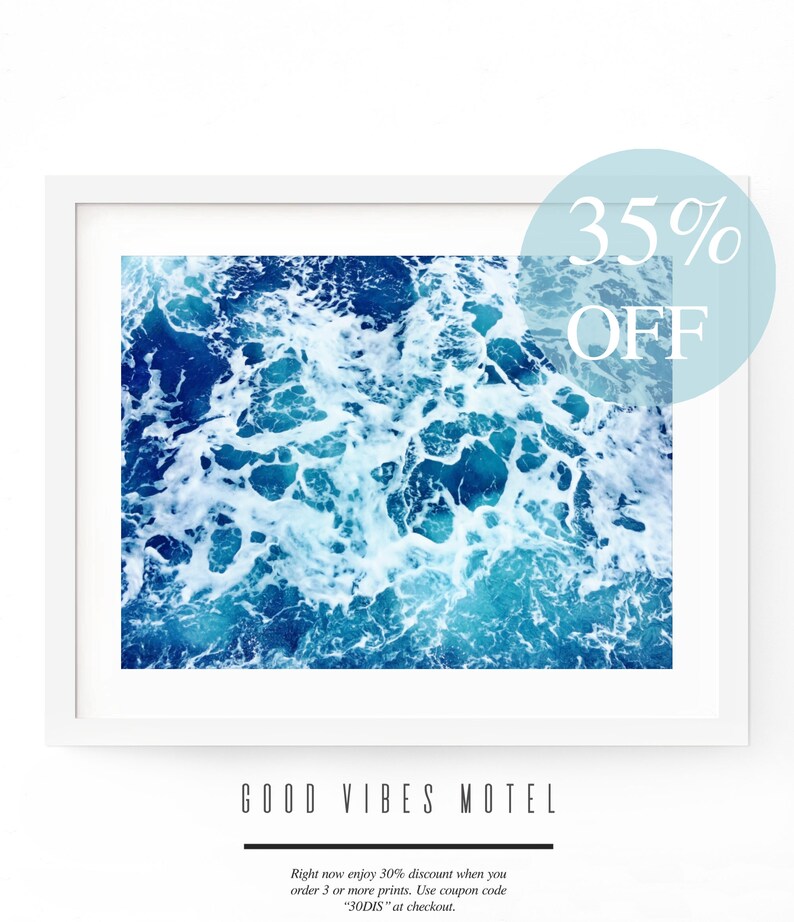May include: A framed print of a photograph of blue ocean water with white foam. The text "GOOD VIBES MOTEL" is below the image. The text "35% OFF" is in a blue circle in the upper right corner of the image.