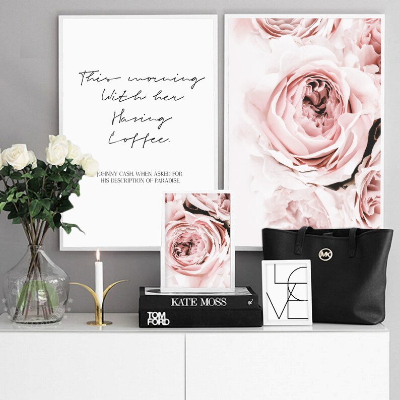 May include: Three framed prints with white frames and white mats. The top left print features a quote about coffee. The top right print features a close-up of pink roses. The bottom print features a close-up of a pink rose.