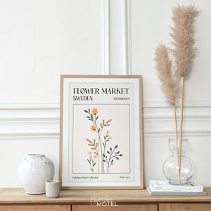 May include: A minimalist poster with a floral illustration in shades of yellow, orange, pink, and green. The poster has the text "Flower Market Sweden Stockholm" and "Exhibition Flower Collection 1998 No.9".