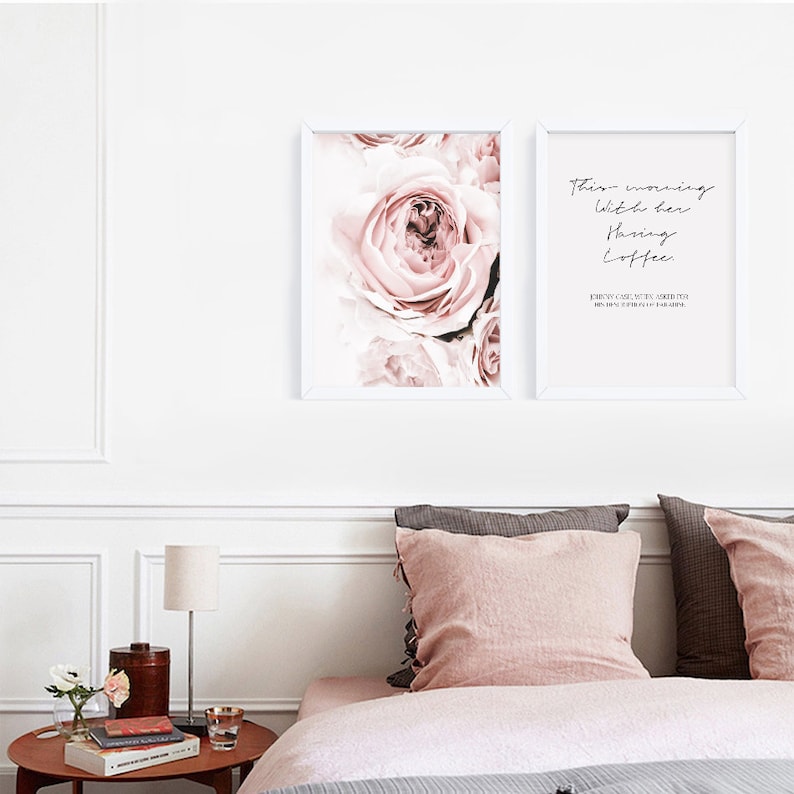 May include: Two framed prints with white frames. The print on the left features a close-up of a pink rose. The print on the right features a quote that reads "These mornings with her having coffee every cup makes me grateful for having her in my life."