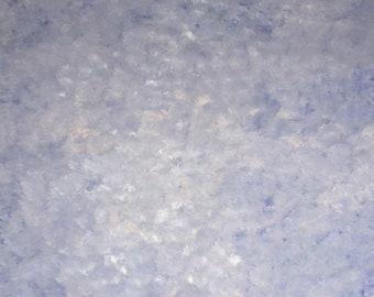 May include: A large, rectangular canvas with a textured, abstract design. The artwork features a blend of light blue, white, and darker blue brushstrokes, creating a cloudy or atmospheric effect. The canvas is mounted on a wooden frame.