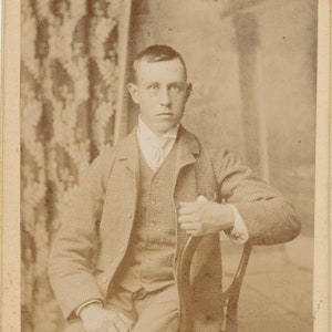Young Man in a Checked Suit on a Tiny Chair. CDV. Kirkcaldy, Scotland.