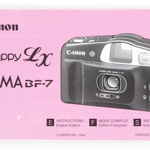May include: A black Canon Prima BF-7 Snappy Lx camera on a pink background. The camera has a Canon lens 35mm 1:4.5. The image also includes text that says "Instructions English Edition", "Mode D'Emploi Edition Française", and "Instrucciones Edición Española".