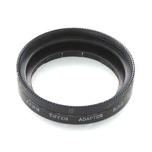 May include: A black metal filter adapter ring for a Tiffen 44mm lens. The ring is labelled "Tiffen Adapter Ring 44mm".