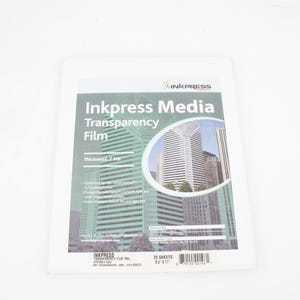 May include: A stack of Inkpress Media Transparency Film sheets. The packaging features the product name, a graphic of city skyscrapers, and the text "Thickness: 7 mil". The package contains 25 sheets, measuring 8.5" x 11".