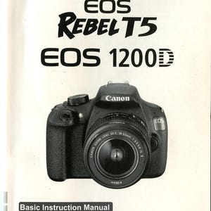 May include: A white Canon EOS Rebel T5 EOS 1200D Basic Instruction Manual featuring a black digital camera with an 18-55mm lens on the cover. The text includes the camera model names, a barcode, and instructions regarding the included CD-ROM.