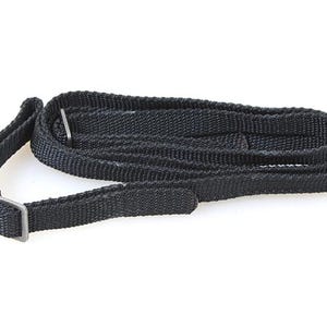 May include: Black camera strap with a silver metal buckle.