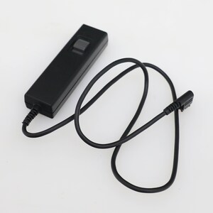 May include: A black remote control with a single button and a black cord.