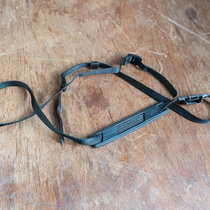 Vintage zwarte Minolta camera riem met nek pad