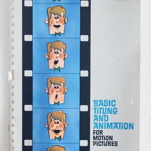 May include: A Kodak Audiovisual Data Book titled Basic Titling and Animation for Motion Pictures. The cover features a vertical blue film strip with a repeating cartoon character illustration, set against a light grey background with white binding holes.