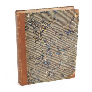 May include: A vintage book with a marbled cover in shades of brown, blue, and yellow. The book has a brown leather spine and a gold title.