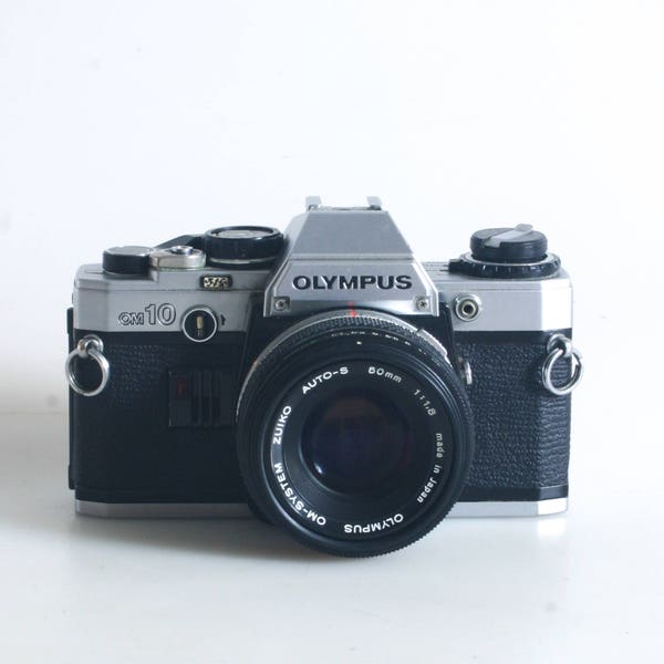 Olympus Om-10 35Mm Slr Film Camera With 50Mm Lens With Cap And Two New Batteries