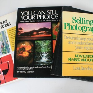 May include: Three photography books are shown, with titles such as "Use & Display Your Pictures", "You Can Sell Your Photos", and "Selling Photographs". The books have colourful covers and various images, including a woman, landscapes, and flowers.