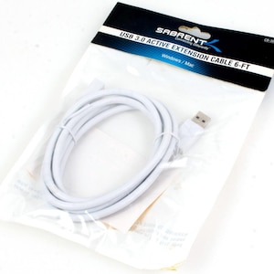 May include: White USB 3.0 active extension cable, 6 feet long, packaged in a clear plastic bag with a black and white label that reads "SABRENT Connecting Differently USB 3.0 ACTIVE EXTENSION CABLE 6-FT Windows/Mac CB-306W"