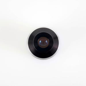 May include: A white ceramic mug with a black handle and the text "But First, Coffee" in a bold, black font. The mug is set against a neutral background, highlighting its simple design.