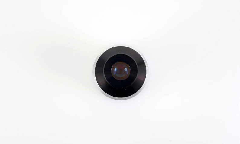 May include: A white ceramic mug with a black handle and the text "But First, Coffee" in a bold, black font. The mug is set against a neutral background, highlighting its simple design.