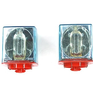 May include: Two blue and red electrical relays with clear plastic covers and visible internal components.