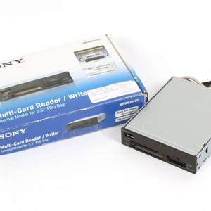 May include: A black Sony Multi-Card Reader/Writer internal model for a 3.5 inch floppy disk drive bay. The box shows the product with the text "Sony Multi-Card Reader/Writer Internal Model for 3.5" FDD Bay" and "MRW152D-U1".