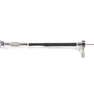 May include: A silver and black flexible extension for a screwdriver. The extension has a black rubberized grip and a silver swivel head.