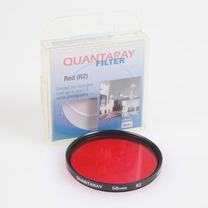 May include: A red Quantaray filter with a black rim, 58mm, and a clear plastic case. The case has the text "QUANTARAY FILTER" and "Red (R2)". The filter is designed to create the strongest contrast in black and white photography.