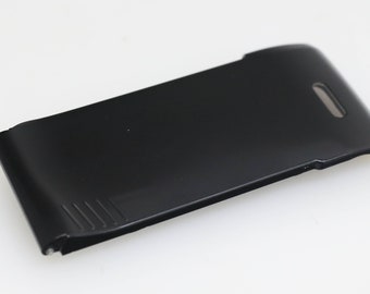 May include: Black plastic phone case with a curved design and a small hole on the top.
