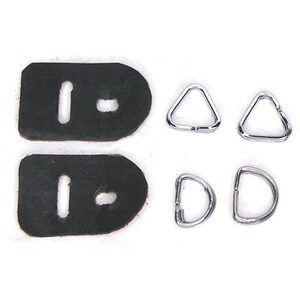 May include: A collection of leather and metal hardware components. The set includes two black leather pieces with slots, two silver triangle rings, and two silver D-rings. All items are displayed against a white background.