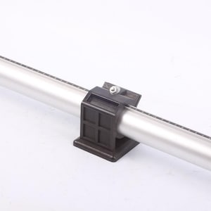 May include: A silver-colored, cylindrical measuring tool with a black base and bracket. The cylinder has a ruler printed along its length. The bracket is square and has a screw on top.