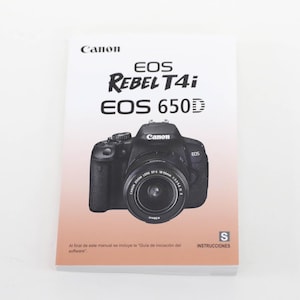 May include: A Canon EOS Rebel T4i / EOS 650D camera manual. The cover features the Canon logo, camera model names, and an image of the camera with a zoom lens. The bottom of the cover has Spanish text and the word "INSTRUCTIONS".