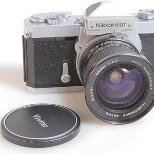 Nikon film camera  Nikkormat FT W/ 28MM F 2.5 Lens w/Front Cap