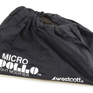 May include: Black nylon Micro Apollo Light Modifier bag with white text. The bag has a drawstring closure and the Westcott logo. The bag is designed to modify light for photography.