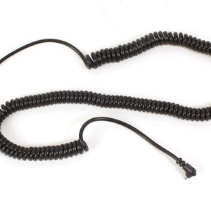 May include: A black coiled phone cord with two connectors on the ends.
