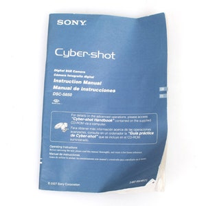 May include: A blue instruction manual for a Sony Cyber-shot DSC-S650 digital camera. The manual includes text in English and Spanish. The cover displays the Sony logo and the words "Cyber-shot".