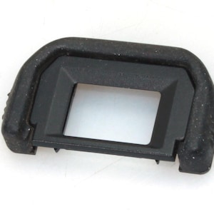 May include: Black camera body cap with a rectangular opening.