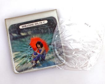 May include: A vintage record album cover featuring a woman sitting under a red umbrella in a forest setting. The album is titled "SPIRATONE SFS CS-C".