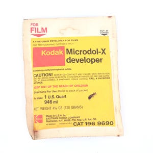 May include: Vintage Kodak Microdol-X developer packet. The yellow and red packet has the Kodak logo and product information. It contains 4 1/2 oz (120 grams) of developer. The packet has a warning and instructions.