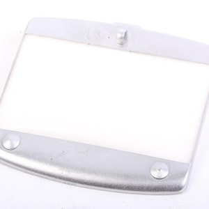 May include: A rectangular, silver light fitting with a white, translucent centre. The fitting has rounded edges and two circular rivets on the bottom. A small, raised loop is centered on the top edge.