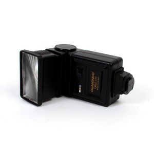 May include: A black flash unit with a swiveling head and a diffuser. The flash unit is labeled "QUANTARRAY CRS2-270".