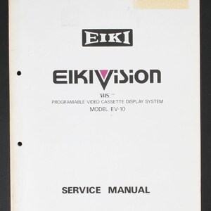 May include: A white service manual for the Eiki Eikivision VHS programmable video cassette display system model EV-10. The cover features black text and logos, including the Eiki brand name and the specific model designation printed in the center.