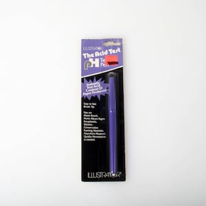 May include: A purple "The Acid Test Pen" in its original packaging. The packaging is black with purple and white text. The pen is a dark purple color. The packaging includes the text "Instantly Test Acid Content Of Paper Products".